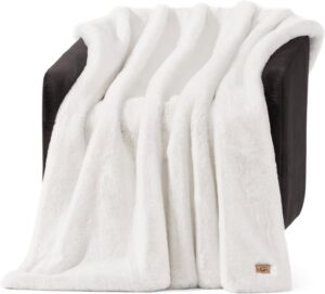 UGG Euphoria faux fur throw blanket in White Snow draped over a bed for cozy luxury home decor