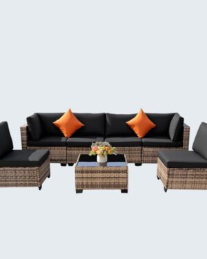 A stunning FHFO 7 Piece Yellow and Black Rattan Sectional Sofa set with plush cushions and a coffee table, displayed in a backyard garden setting