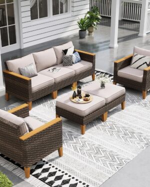 Sophia & William 7-piece wicker rattan sectional sofa set in a backyard, featuring two corner sofas, single chairs, an armless couch, and ottomans on a wooden deck.